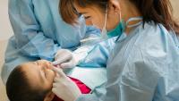 dentist smiling at child during exam